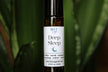 Roll-on bottle labeled 'Deep Sleep' by Blue Sage with a green leafy background