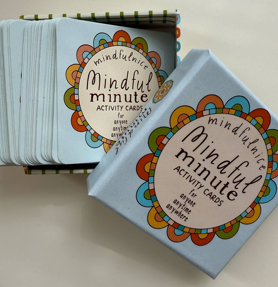 Mindful minute activity cards with colorful packaging on a light background