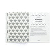 Book with geometric pattern on cover and open page showing text