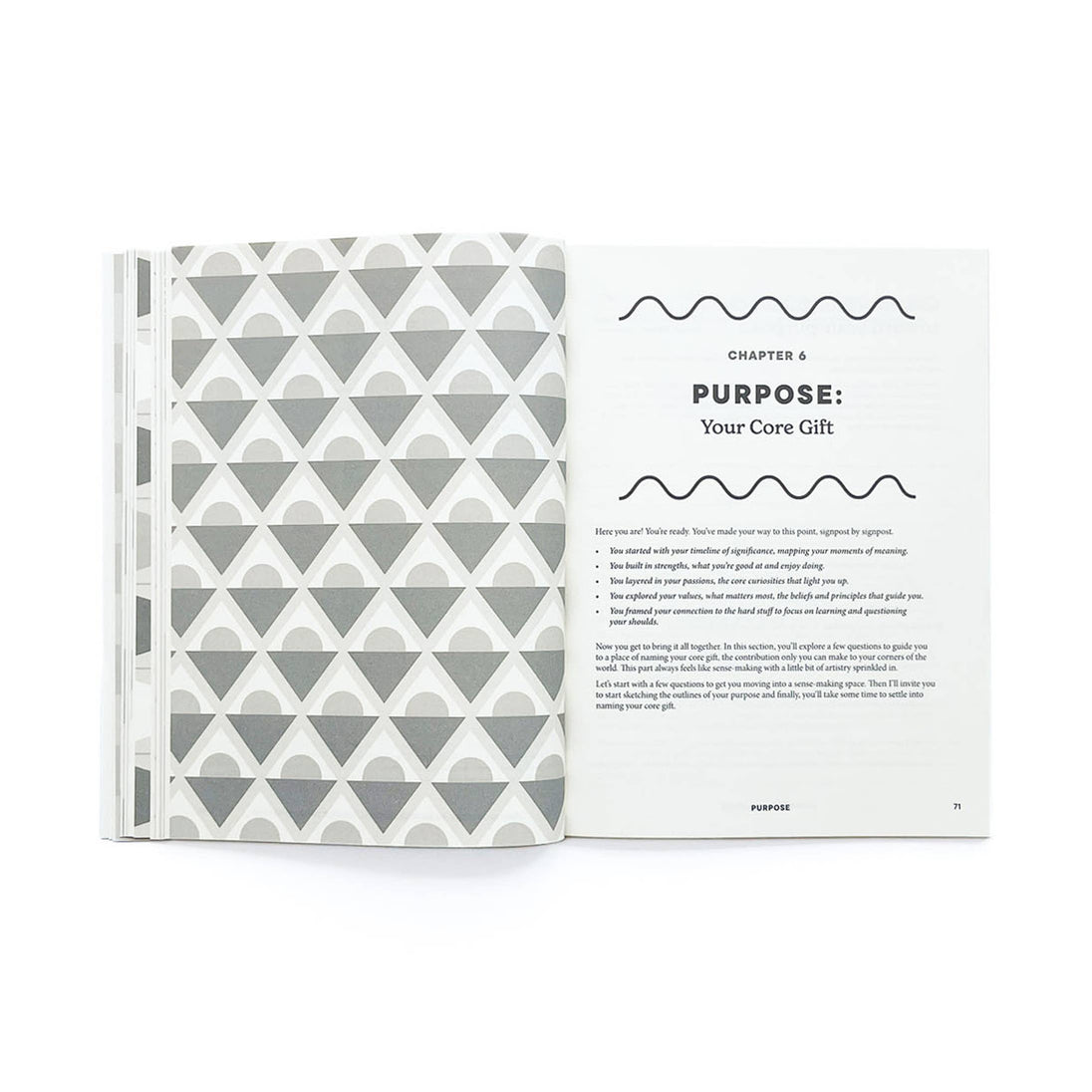 Book with geometric pattern on cover and open page showing text