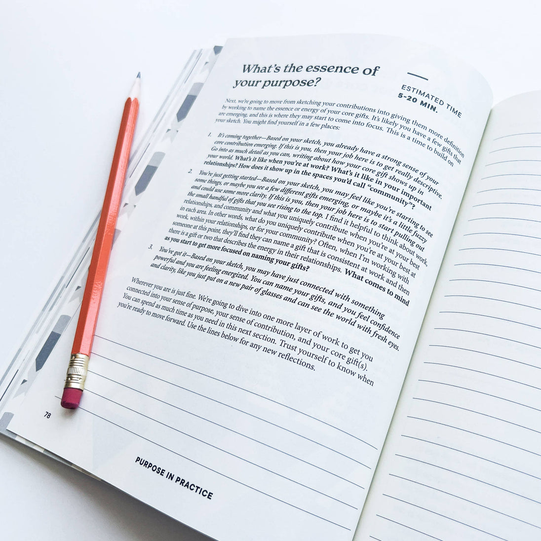 Open book with a pencil on a white background